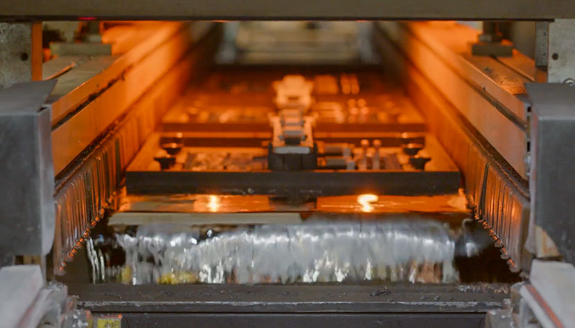 Circuit boards moving through a wave solder machine